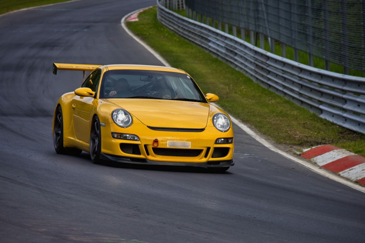 A classic Porsche 911 Carrera parked on a scenic road